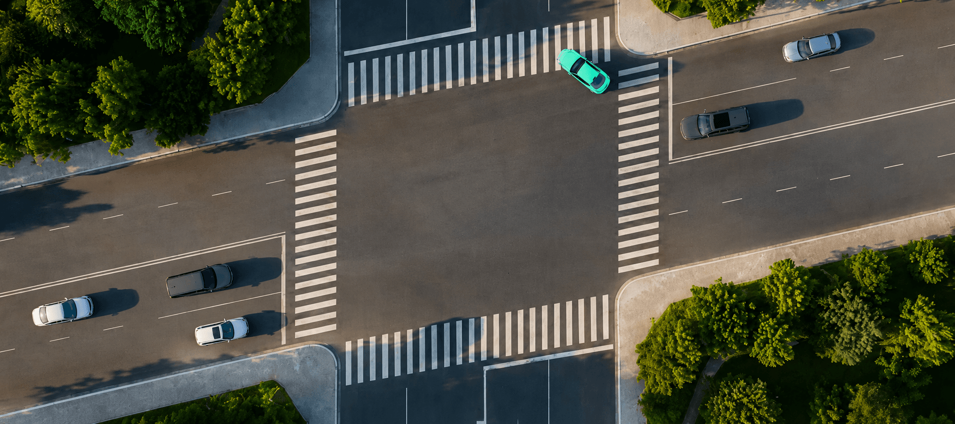 Aerial view of a busy city intersection with vehicles crossing